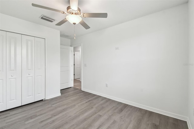 2139 Stellar Brilliance Way, Lutz, FL 33558 - unfurnished bedroom with light wood-type flooring, a closet, and a ceiling fan