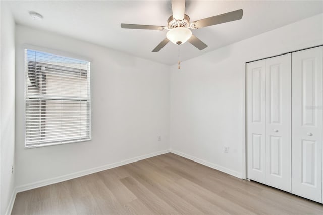 2139 Stellar Brilliance Way, Lutz, FL 33558 - unfurnished bedroom with light wood-type flooring, a closet, and ceiling fan
