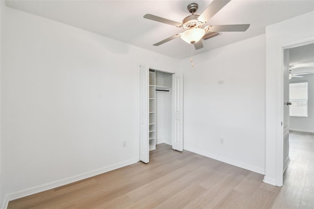 2139 Stellar Brilliance Way, Lutz, FL 33558 - unfurnished bedroom with light wood finished floors, a closet, and a ceiling fan