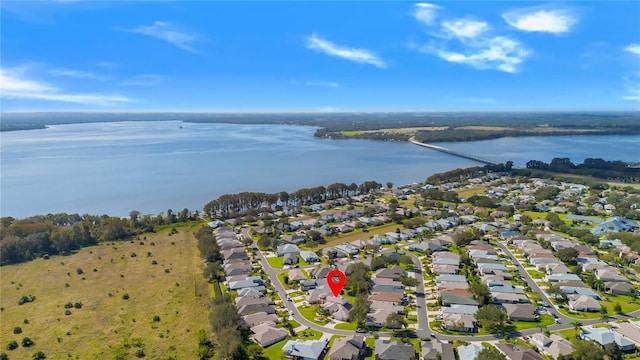 5740 Bounty Cir, Tavares, FL 32778 - aerial view of property and surrounding area featuring a nearby body of water and nearby suburban area