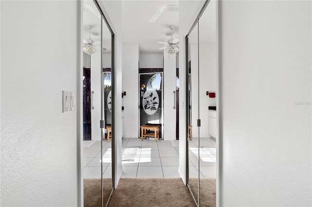 5740 Bounty Cir, Tavares, FL 32778 - hallway with tile patterned floors, carpet flooring, and a textured wall