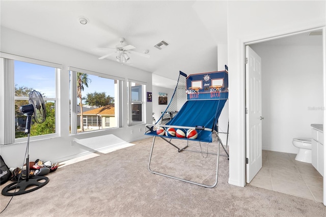 5740 Bounty Cir, Tavares, FL 32778 - recreation room with carpet, a ceiling fan, and tile patterned flooring