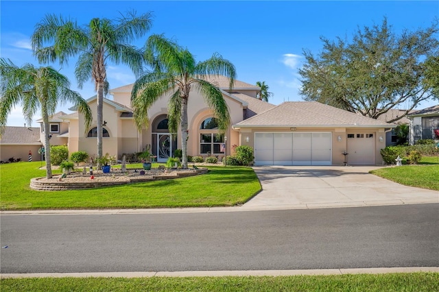 5740 Bounty Cir, Tavares, FL 32778 - view of front of house with a garage, stucco siding, driveway, and a front yard