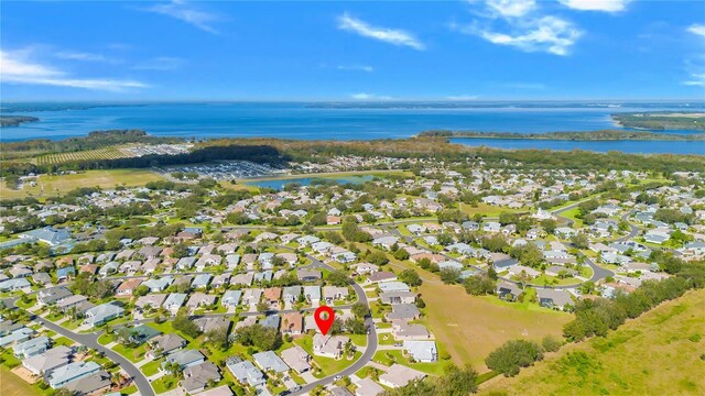 5740 Bounty Cir, Tavares, FL 32778 - aerial view of property's location featuring a large body of water and nearby suburban area