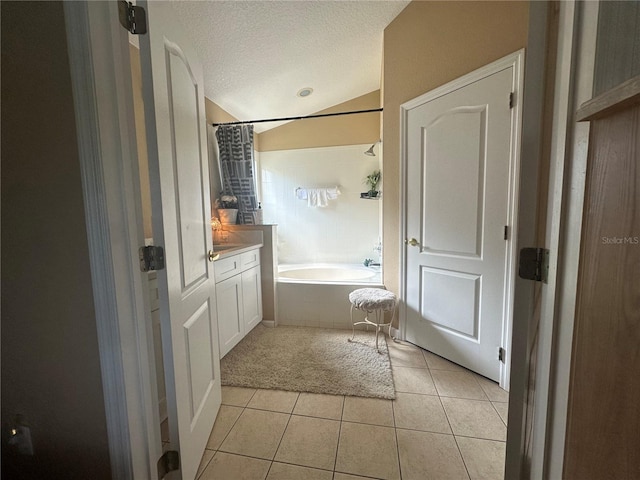 15509 Markham Dr, Clermont, FL 34714 - full bath featuring vanity, a textured ceiling, tile patterned floors, lofted ceiling, and tiled shower / bath combo