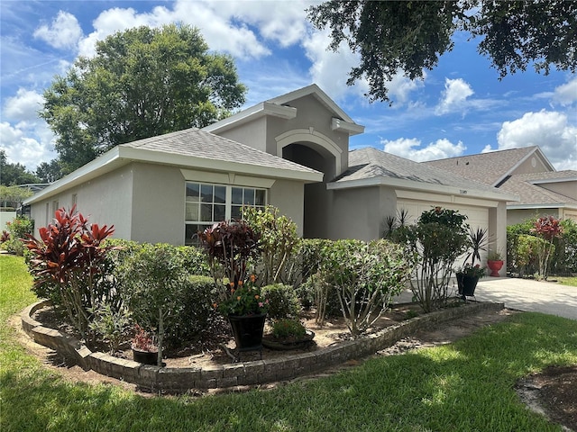 15509 Markham Dr, Clermont, FL 34714 - view of front of property featuring a garage, stucco siding, roof with shingles, and concrete driveway
