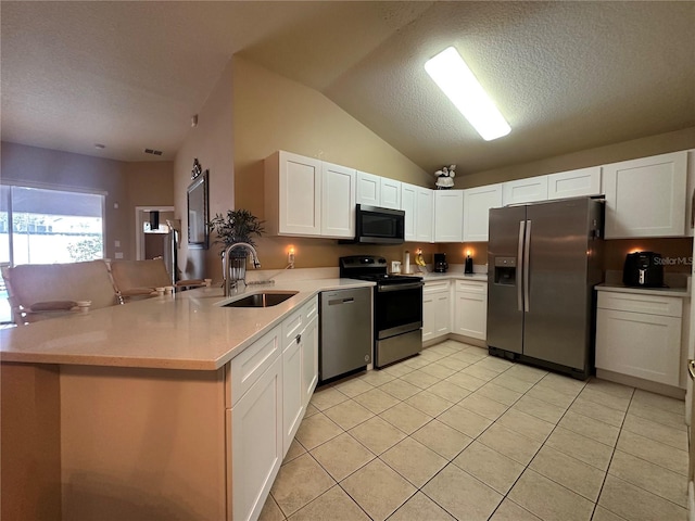 15509 Markham Dr, Clermont, FL 34714 - kitchen featuring stainless steel appliances, a peninsula, light tile patterned flooring, light countertops, and white cabinets