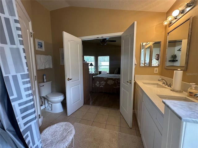 15509 Markham Dr, Clermont, FL 34714 - ensuite bathroom with vaulted ceiling, a ceiling fan, tile patterned floors, and double vanity