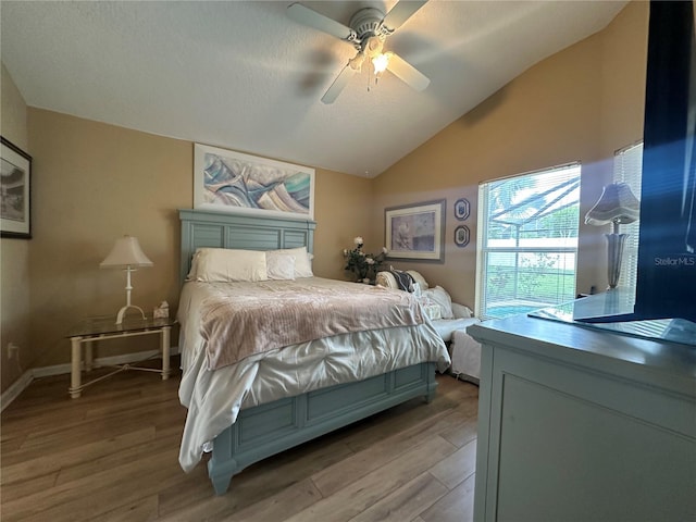 15509 Markham Dr, Clermont, FL 34714 - bedroom featuring light wood-style floors, lofted ceiling, and a ceiling fan