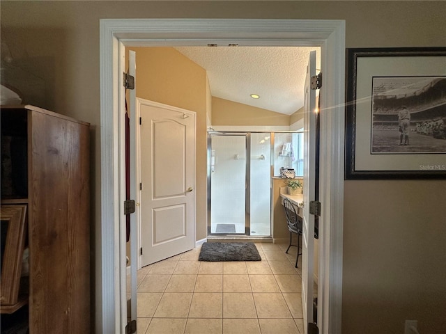 15509 Markham Dr, Clermont, FL 34714 - bathroom with tile patterned flooring, a shower stall, lofted ceiling, and a textured ceiling