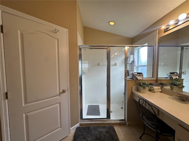15509 Markham Dr, Clermont, FL 34714 - bathroom featuring lofted ceiling, a textured ceiling, a stall shower, tile patterned flooring, and vanity