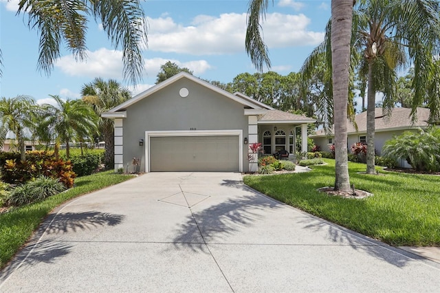 2512 Baywater Rd, Tavares, FL 32778 - single story home with stucco siding, a front yard, concrete driveway, and a garage
