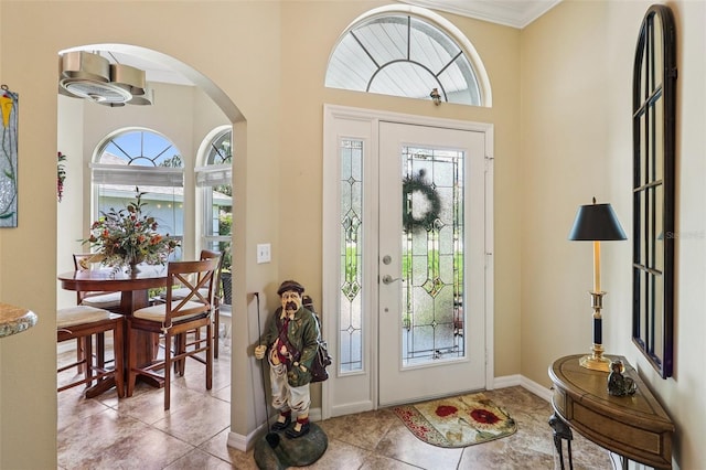2512 Baywater Rd, Tavares, FL 32778 - foyer entrance with tile patterned flooring, arched walkways, and ornamental molding