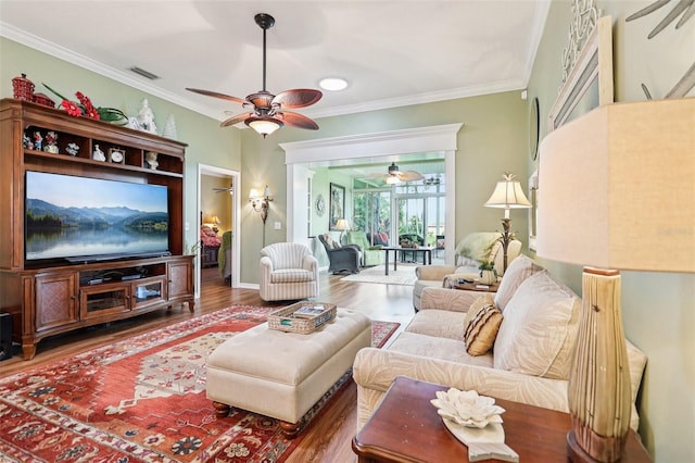 2512 Baywater Rd, Tavares, FL 32778 - living area featuring a ceiling fan, crown molding, and wood finished floors