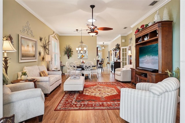 2512 Baywater Rd, Tavares, FL 32778 - living area with a chandelier, wood finished floors, crown molding, and ceiling fan