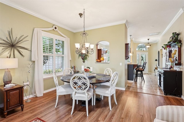 2512 Baywater Rd, Tavares, FL 32778 - dining room featuring ornamental molding, wood finished floors, and a chandelier
