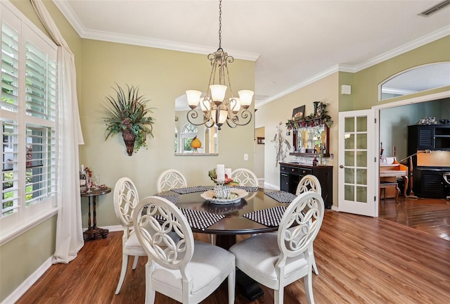 2512 Baywater Rd, Tavares, FL 32778 - dining space featuring wood finished floors, a chandelier, crown molding, and french doors