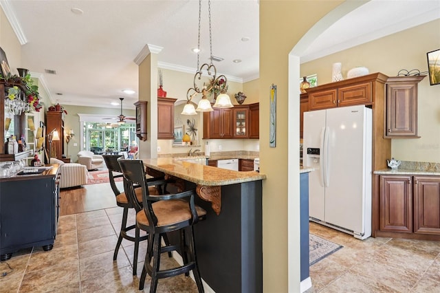 2512 Baywater Rd, Tavares, FL 32778 - kitchen with white appliances, crown molding, ceiling fan, arched walkways, and light stone counters