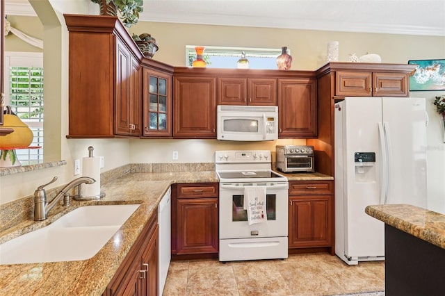 2512 Baywater Rd, Tavares, FL 32778 - kitchen featuring white appliances, ornamental molding, glass insert cabinets, light stone counters, and brown cabinets