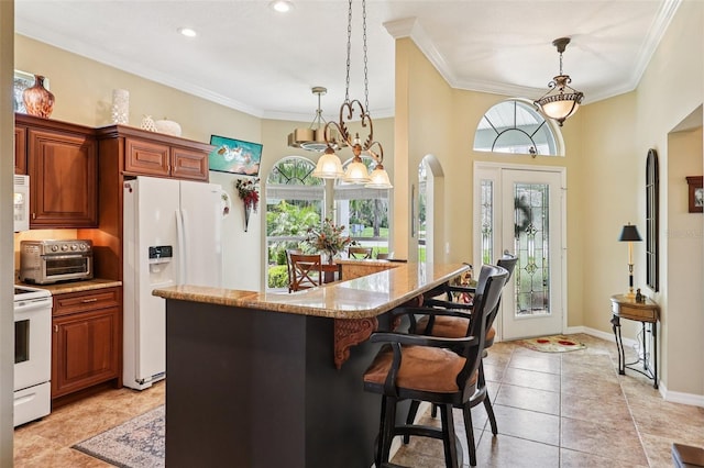 2512 Baywater Rd, Tavares, FL 32778 - kitchen with white appliances, ornamental molding, a breakfast bar area, hanging light fixtures, and light stone countertops