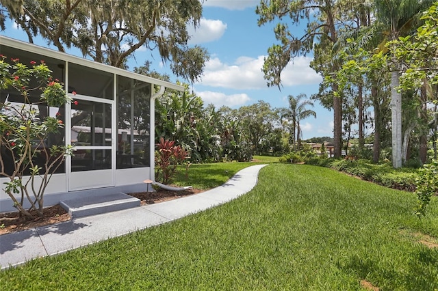 2512 Baywater Rd, Tavares, FL 32778 - view of green lawn with a sunroom