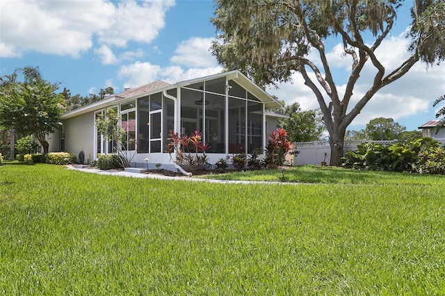 2512 Baywater Rd, Tavares, FL 32778 - back of house featuring a sunroom and stucco siding