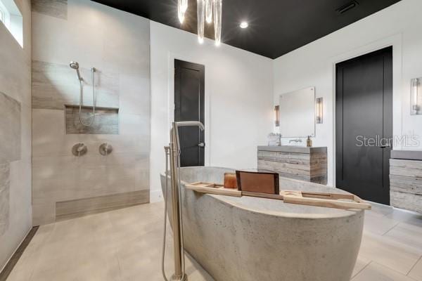 10711 County Road 561, Clermont, FL 34711 - bathroom with a freestanding tub, walk in shower, and vanity