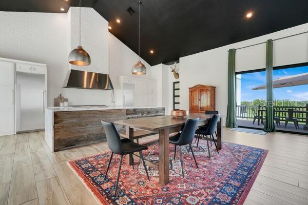 10711 County Road 561, Clermont, FL 34711 - dining area featuring high vaulted ceiling and light wood-style floors
