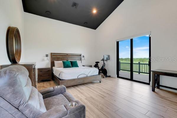 10711 County Road 561, Clermont, FL 34711 - bedroom featuring access to outside, wood finished floors, and high vaulted ceiling