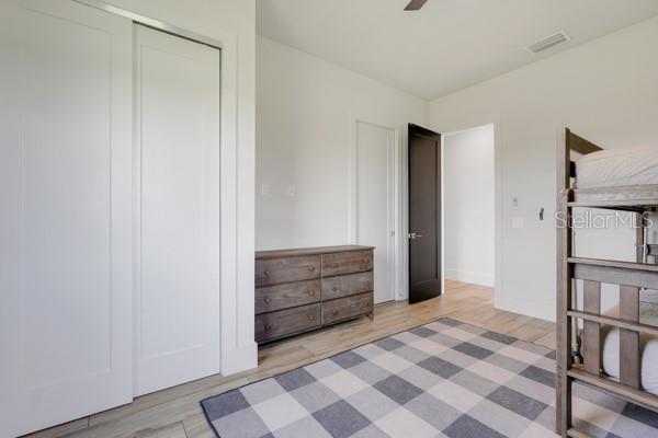 10711 County Road 561, Clermont, FL 34711 - bedroom featuring wood finished floors, ceiling fan, and a closet