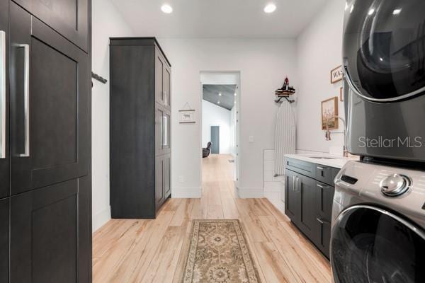 10711 County Road 561, Clermont, FL 34711 - washroom featuring stacked washer / drying machine, cabinet space, light wood-type flooring, and recessed lighting