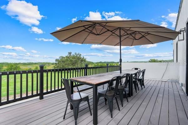 10711 County Road 561, Clermont, FL 34711 - wooden terrace with outdoor dining space and a lawn