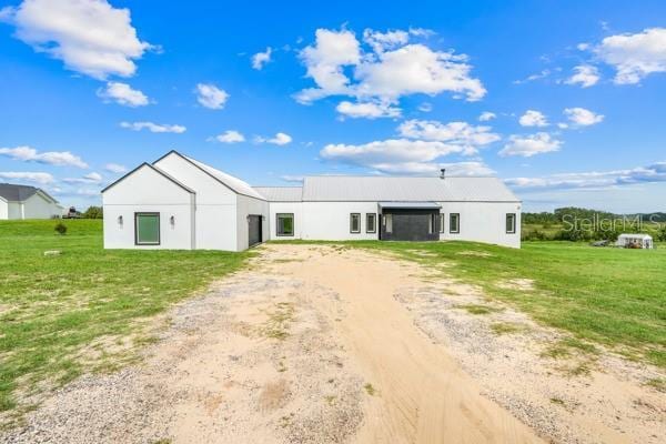10711 County Road 561, Clermont, FL 34711 - view of front of house featuring dirt driveway, stucco siding, and a front lawn