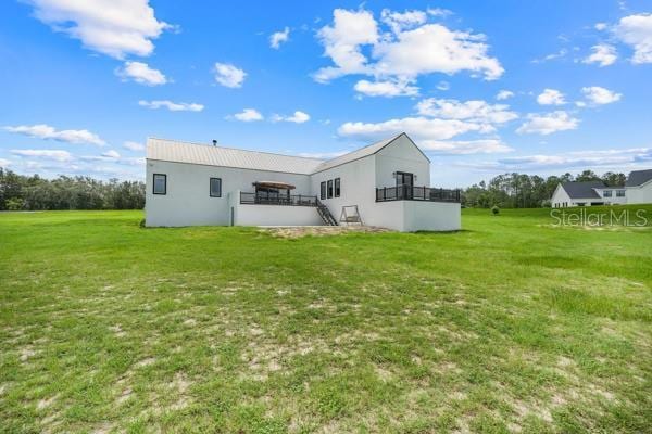 10711 County Road 561, Clermont, FL 34711 - back of property with a yard, stucco siding, and stairs