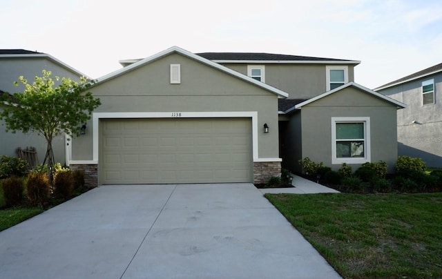 1138 Calico Pointe Cir, Groveland, FL 34736 - traditional-style house featuring stone siding, stucco siding, driveway, and an attached garage