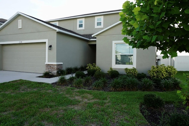 1138 Calico Pointe Cir, Groveland, FL 34736 - traditional-style home with stucco siding, an attached garage, concrete driveway, and a front yard