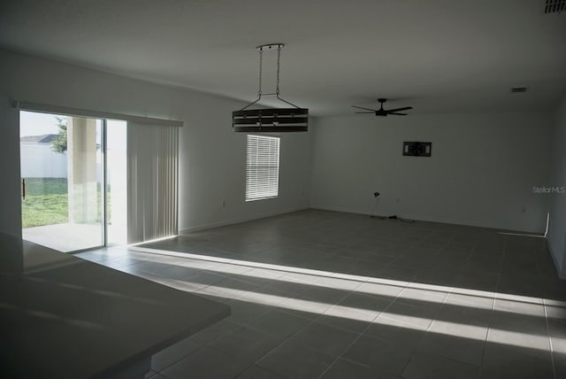 1138 Calico Pointe Cir, Groveland, FL 34736 - spare room with a ceiling fan and tile patterned floors