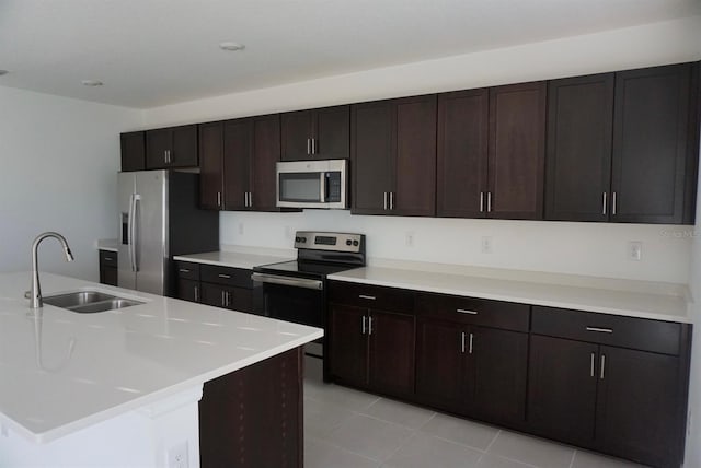 1138 Calico Pointe Cir, Groveland, FL 34736 - kitchen with appliances with stainless steel finishes, light countertops, light tile patterned floors, and dark brown cabinetry