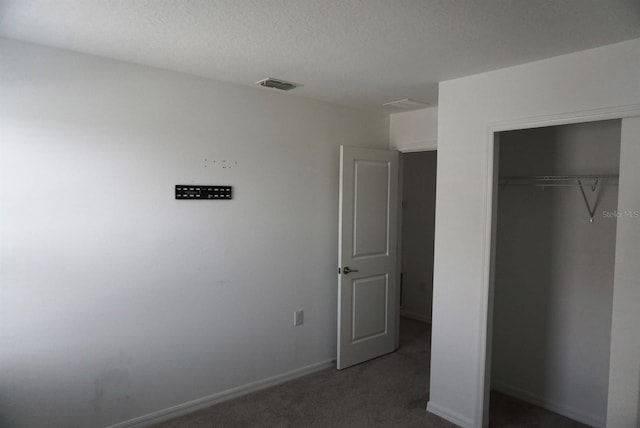 1138 Calico Pointe Cir, Groveland, FL 34736 - unfurnished bedroom with a closet, carpet flooring, and a textured ceiling