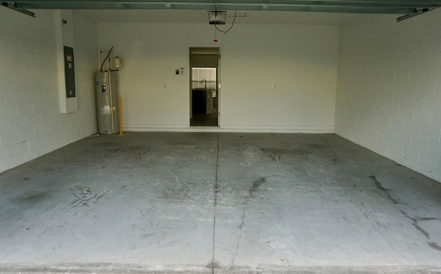 1138 Calico Pointe Cir, Groveland, FL 34736 - garage with electric water heater, a garage door opener, concrete block wall, and electric panel
