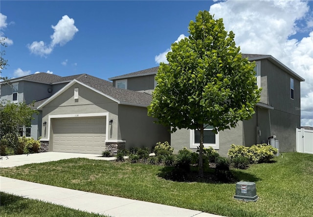 1138 Calico Pointe Cir, Groveland, FL 34736 - view of front of home featuring an attached garage, stucco siding, concrete driveway, and stone siding