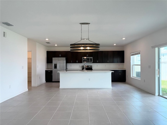 1138 Calico Pointe Cir, Groveland, FL 34736 - kitchen featuring appliances with stainless steel finishes, light countertops, recessed lighting, light tile patterned floors, and decorative light fixtures