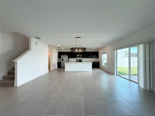 1138 Calico Pointe Cir, Groveland, FL 34736 - unfurnished living room featuring light tile patterned floors, recessed lighting, and stairway