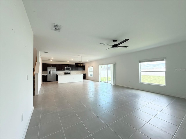 1138 Calico Pointe Cir, Groveland, FL 34736 - unfurnished living room featuring light tile patterned floors, ceiling fan, and recessed lighting