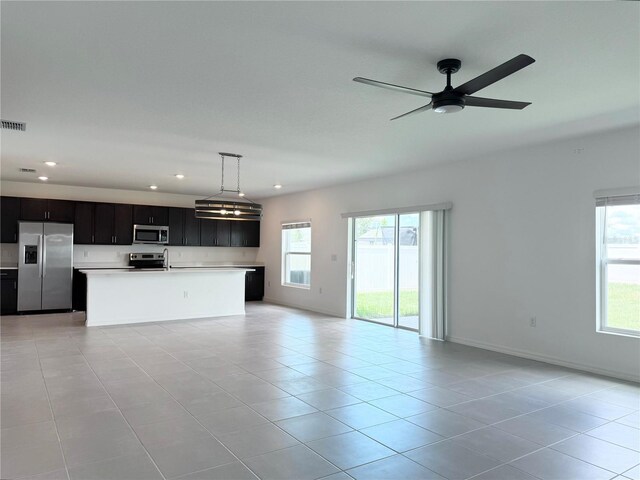 1138 Calico Pointe Cir, Groveland, FL 34736 - unfurnished living room with healthy amount of natural light, recessed lighting, light tile patterned floors, and ceiling fan