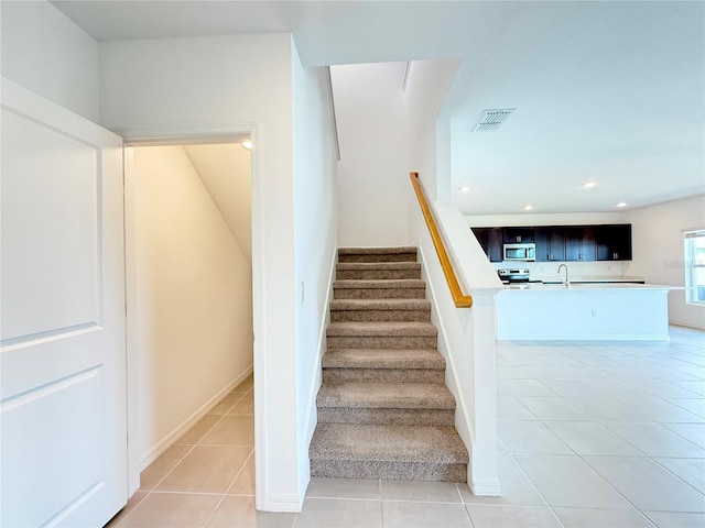 1138 Calico Pointe Cir, Groveland, FL 34736 - stairway featuring tile patterned flooring and recessed lighting