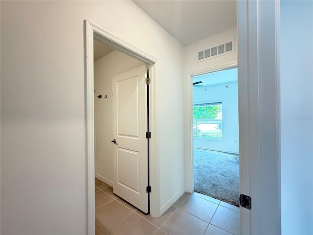 1138 Calico Pointe Cir, Groveland, FL 34736 - hallway with light tile patterned flooring and light carpet