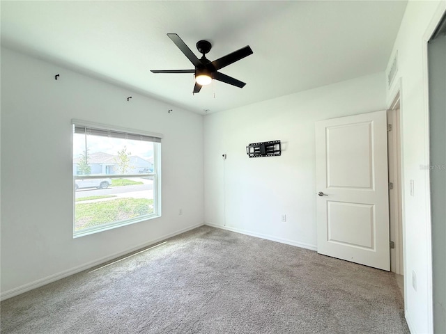 1138 Calico Pointe Cir, Groveland, FL 34736 - carpeted empty room with ceiling fan and baseboards