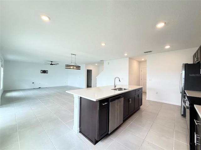 1138 Calico Pointe Cir, Groveland, FL 34736 - kitchen with stainless steel dishwasher, range with electric cooktop, open floor plan, a kitchen island with sink, and light countertops