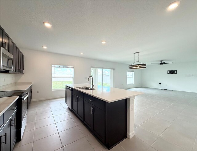1138 Calico Pointe Cir, Groveland, FL 34736 - kitchen with stainless steel appliances, healthy amount of natural light, ceiling fan, light countertops, and recessed lighting
